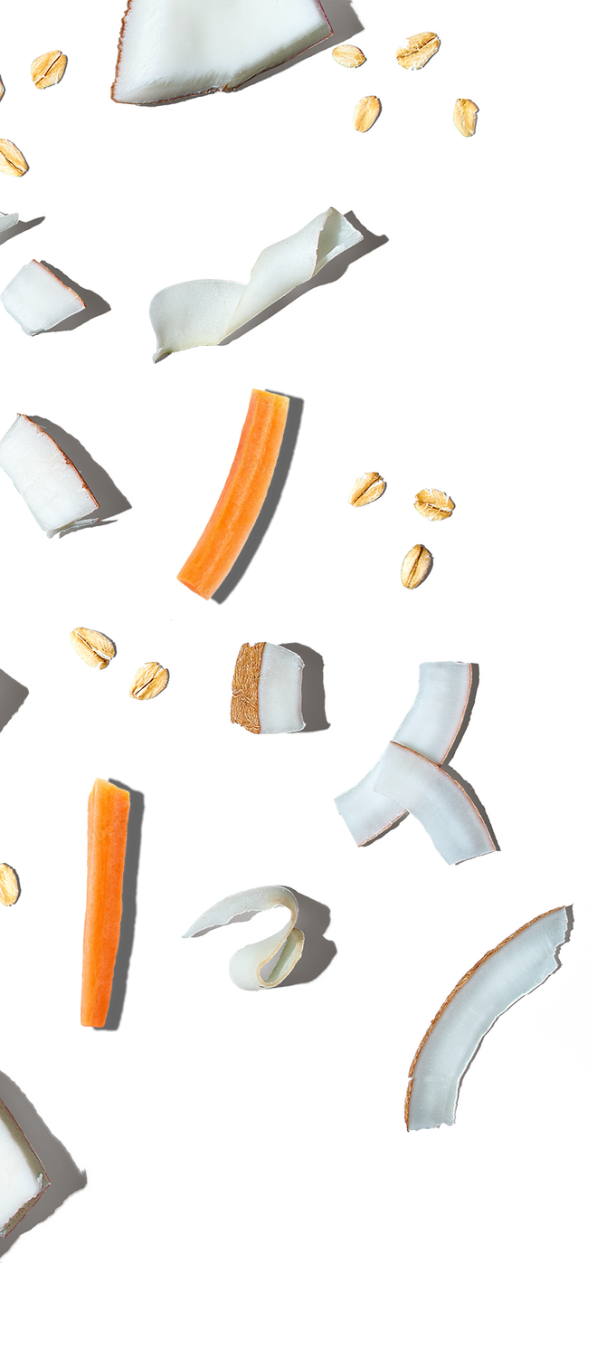 Coconut pieces with orange and yellow specks on a white background