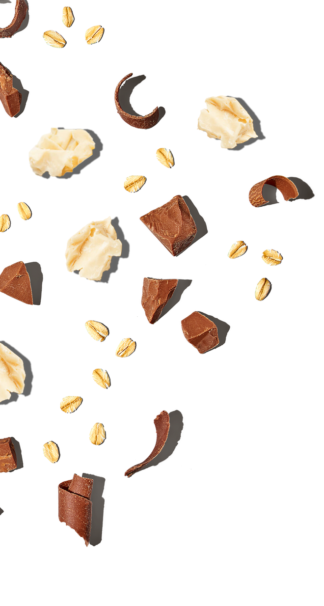 Assorted chocolate pieces and nuts on a white background