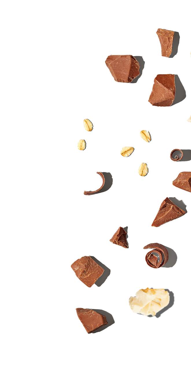 Assorted chocolate pieces and nuts on a white background